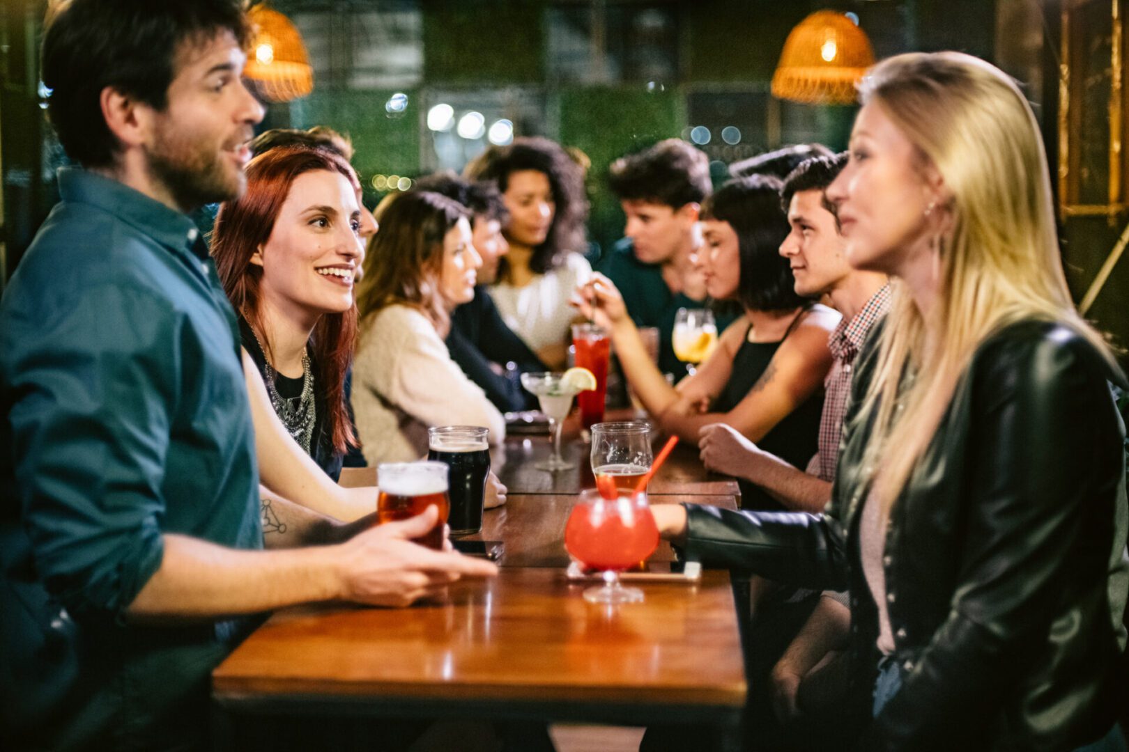 Group of friends hanging out in a Bar at Night